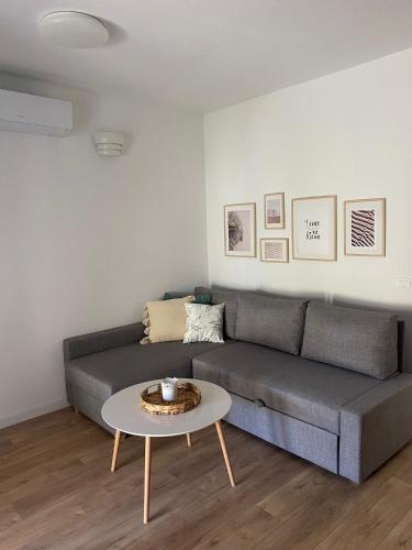 a living room with a couch and a table at Bura in Jelsa