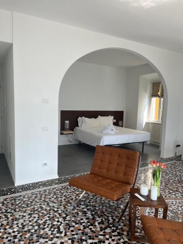 a bedroom with a bed and a couch and a chair at Divina Vita Apartments in Varenna