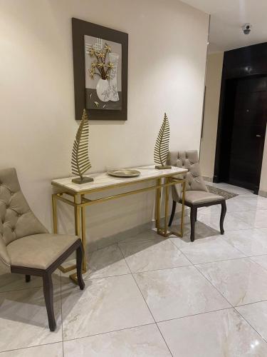 a dining room with a table and two chairs at فندق فيوري - شارع شهار in Taif