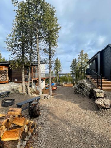 a group of logs and benches in front of a building at Stone Cove Waterfront Adults Only B&B in Tobermory