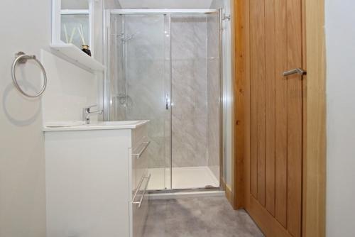 a bathroom with a shower and a sink and a toilet at Sea Breeze in Clachan