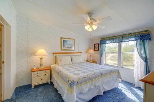 a bedroom with a bed with a ceiling fan and a window at Serene Home 2 Decks, 3 Mi to Blue Ridge Pkwy in Willis