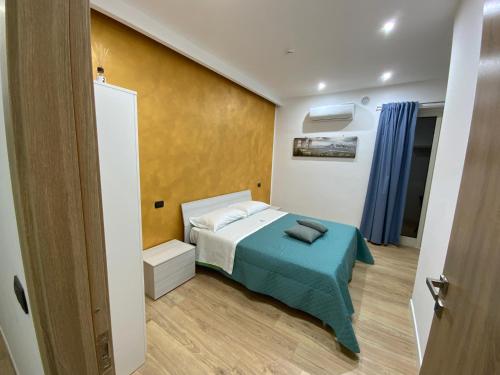 a small bedroom with a bed with a blue blanket at B&B Gisa House in Pomigliano dʼArco