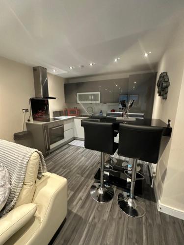 a kitchen and living room with a couch and a table at Bond Street Luxury Apartment Central Chelmsford in Chelmsford