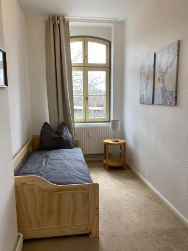 a bedroom with a bed and a window at Ferienwohnung Bress OG in Ueckermünde