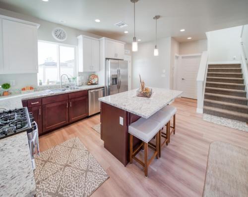 a kitchen with a island with a counter top at South Zion Coral Cliffs - 4 bed, 3 bath, hot tub, deck in Hildale