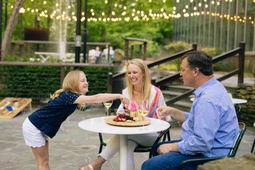 a man and a girl sitting at a table with a plate of food at Crowne Plaza Atlanta Perimeter at Ravinia by IHG in Atlanta
