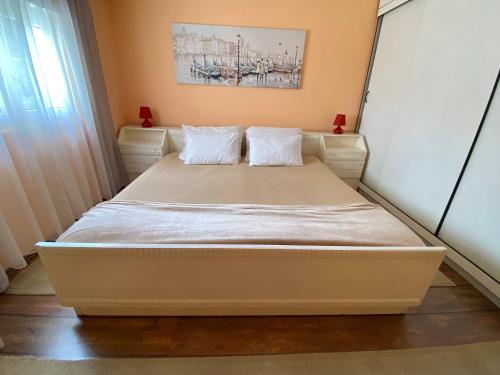 a bed with two pillows on it in a room at Village house Iva in Virpazar