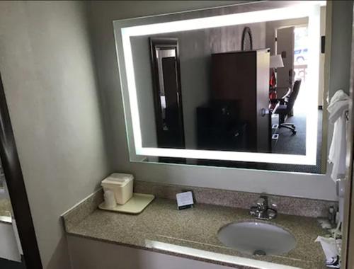 a bathroom with a sink and a large mirror at Quality Inn Christiansburg - Blacksburg in Christiansburg