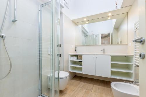 a bathroom with a shower and a toilet and a sink at FEEL - Patio del Sole in Bergamo