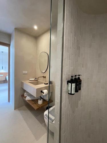 a bathroom with a sink and a mirror at Melitsina Village Hotel in Kardamili