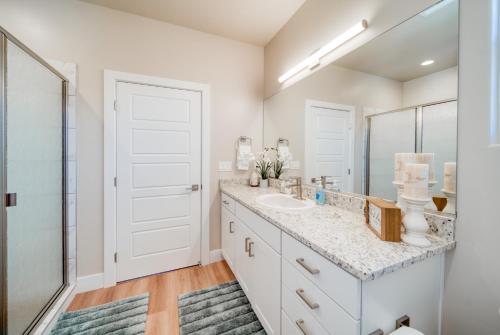 a bathroom with a sink and a mirror at New South Zion Coral Cliffs - 4 bed, 3 bath, hot tub, deck in Hildale