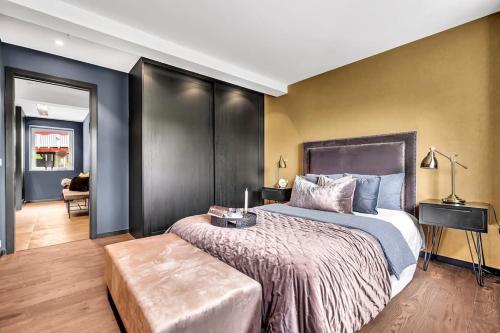 a bedroom with a large bed with a large headboard at Panorama Nidelva in Trondheim