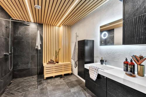 a bathroom with a shower and a sink at Panorama Nidelva in Trondheim