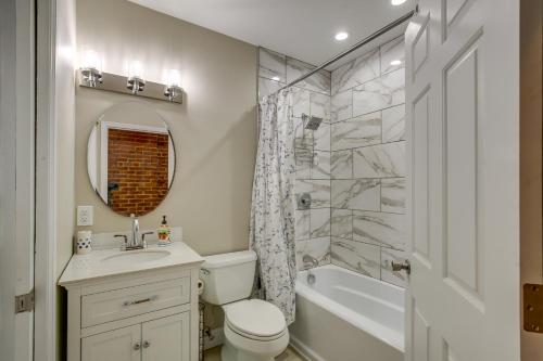 a bathroom with a sink and a toilet and a tub at St Louis Vacation Rental about 2 Mi to Downtown in Soulard