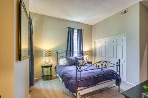 a bedroom with a bed with purple sheets and a window at St Louis Vacation Rental about 2 Mi to Downtown in Soulard