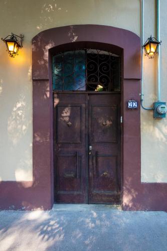 a large wooden door on a building with two lights at Meztli: Casa Boutique & Spa in Mexico City