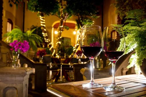 two glasses of red wine sitting on a table at Meztli: Casa Boutique & Spa in Mexico City