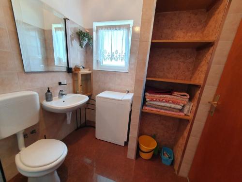 a small bathroom with a toilet and a sink at Apartment with Terace and sea view Marica in Krk