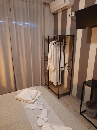 a room with a clothes rack with a white shirt at Cabo Verde in Agia Triada