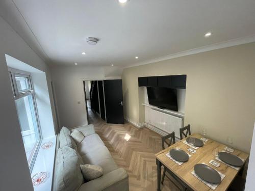 a living room with a couch and a table at The Mount in Swansea
