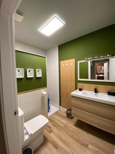 a bathroom with a toilet and a sink and a mirror at Casa Aturuxo in Belesar