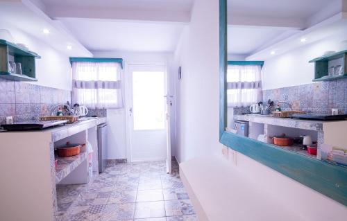 a bathroom with two sinks and a mirror at Ta Kymata Karpathos in Karpathos Town