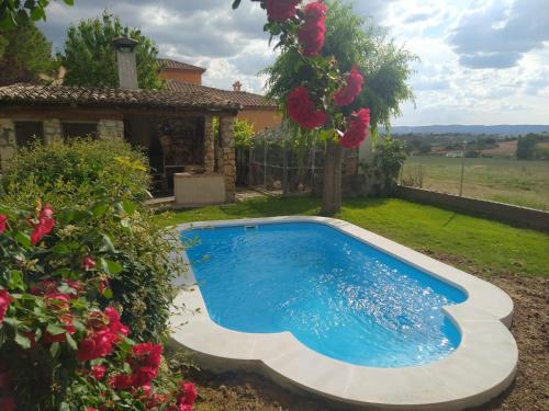a swimming pool in the yard of a house at Casa Rural La Loma in Nohales
