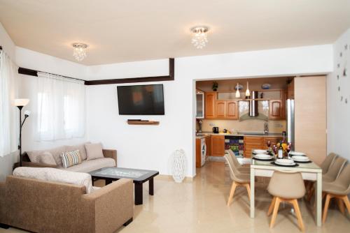 een woonkamer met een bank en een tafel bij Villa Elia in Kolimbia