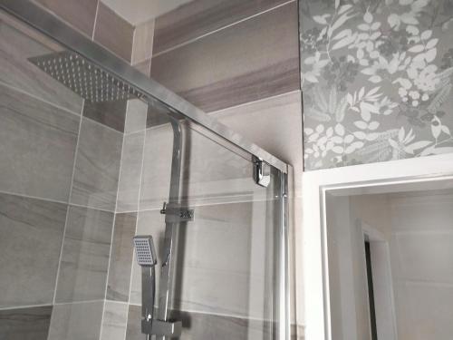 a shower with a glass door in a bathroom at Garden Cottage in Guisborough