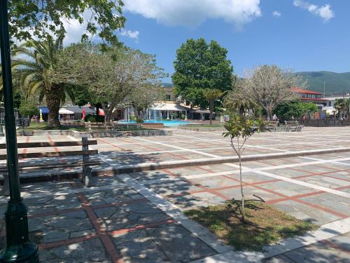 a park with benches and a tree in the middle at Asprovalta M in Asprovalta