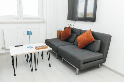 a living room with a couch and a table at HEIMATEL - Suiten, Apartments und Studios in Scheidegg