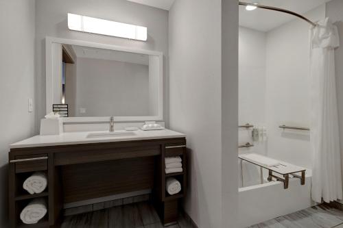 a bathroom with a sink and a mirror at Home2 Suites By Hilton Petaluma in Petaluma
