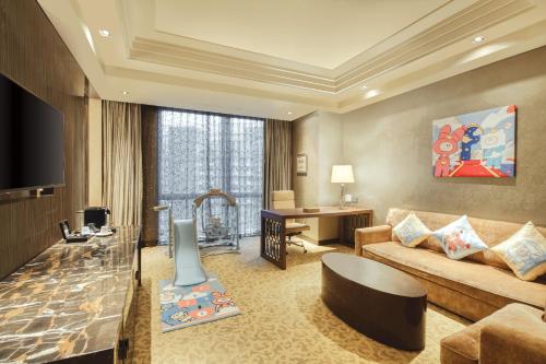 a living room with a couch and a table at Crowne Plaza Beijing Chaoyang U-Town by IHG - within 30 minutes to Forbidden City by metro in Beijing