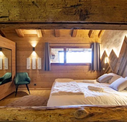 a bedroom with a large bed and a window at Chalet Le Perray Alpine Lodge in Abondance