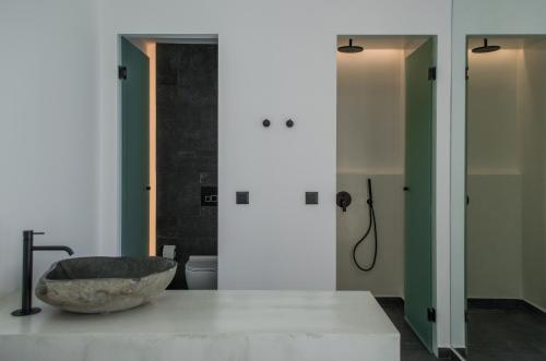 a bathroom with a stone bowl on a counter at Hygge Suites in Hersonissos