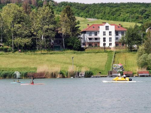a group of people on kayaks on a lake at Life Apartman Orfű in Orfű