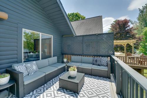 a patio with a couch and a table at Diamond Lake Waterfront Cabin with Deck and Dock! in Tustin