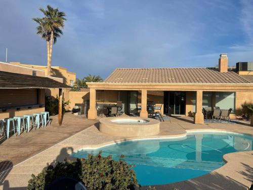 a house with a swimming pool in front of a house at Villa La Isla PANORAMIC VIEWS, Outdoor Kitchen, sleeps 16 in Lake Havasu City