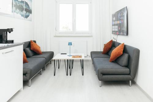 a living room with two couches and a table at Rosenalm Scheidegg in Scheidegg