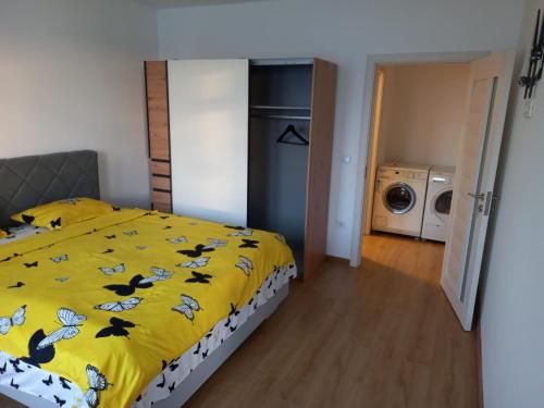 a bedroom with a bed with a yellow comforter at Casa Dana in Sibiu