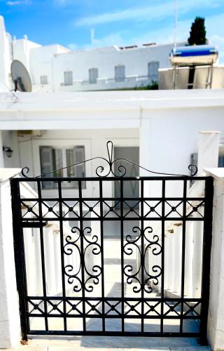 a black iron gate in front of a white building at Poseidonia's Breeze in Posidhonía