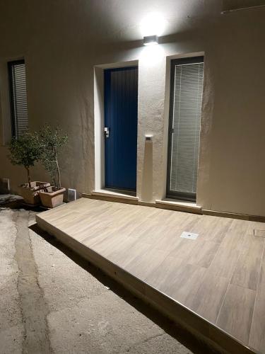 a room with a wooden floor and a blue door at Acquamarina Casa Vacanze in Marina San Vito