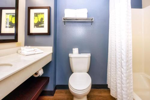 a bathroom with a toilet and a sink and a tub at Homestyle Studio Suites in Annapolis