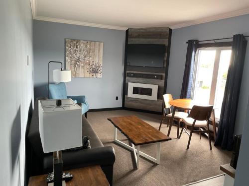 a living room with a couch and a table at Acadian Hotel in Stephenville