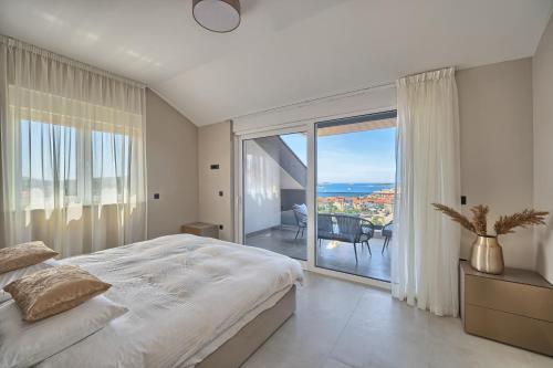 a bedroom with a large bed and a large window at Residence Franc in Primošten
