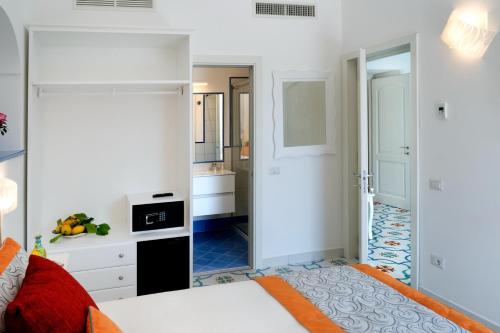 a bedroom with a bed and a bathroom at Suites in the Amalfi Coast - GuestHouse with Terrace near Amalfi - Breathtaking View of Ravello in Scala