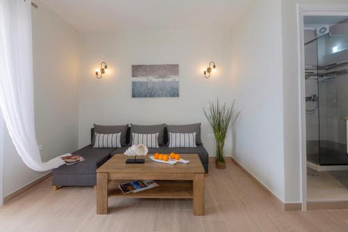a living room with a couch and a table at sofia's apart 4u (114) in Glyfada