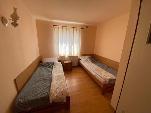 a bedroom with two beds and a window at "U Jędrusia" in Żychlin