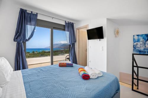a bedroom with a bed with a view of the ocean at Luxury Villas In Nopigia With A Private Pool - Isabel Artemis in Nopíyia